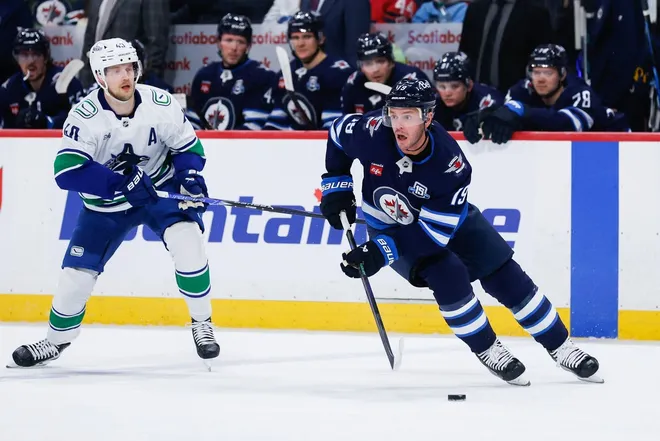 Mar 7, 2026; Winnipeg, Manitoba, CAN; Winnipeg Jets forward Jonathan Toews (19) skates away from Vancouver Canucks forward Elias Pettersson (40) during the first period at Canada Life Centre.