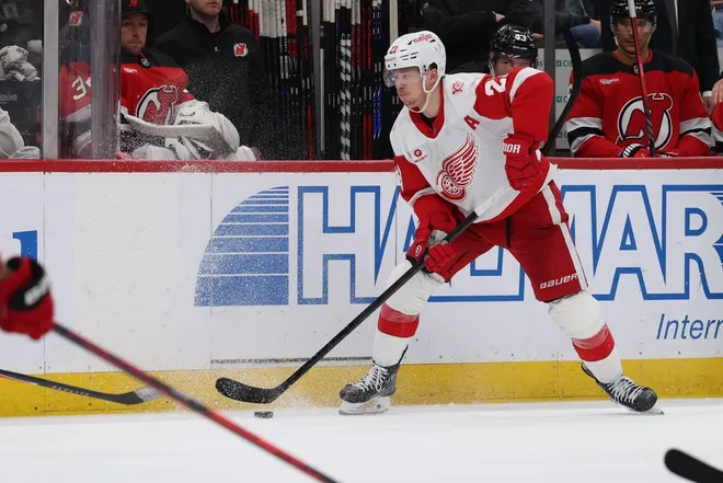 Mar 8, 2026; Newark, New Jersey, USA; Detroit Red Wings left wing Lucas Raymond (23) looks to pass the puck against the New Jersey Devils during the third period at Prudential Center.