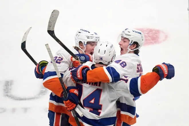 Mar 7, 2026; San Jose, California, USA; New York Islanders center Bo Horvat (14) celebrates with defenseman Matthew Schaefer (48) and right wing Simon Holmstrom (92) after scoring the game-winning goal against the San Jose Sharks during the overtime period at SAP Center at San Jose.