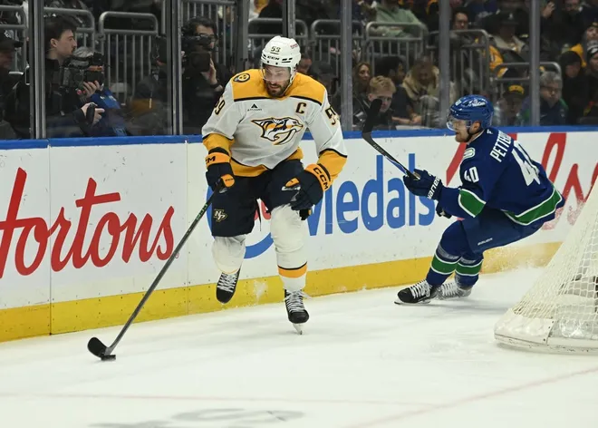 Mar 12, 2026; Vancouver, British Columbia, CAN; Nashville Predators defenseman Roman Josi (59) skates with the puck against Vancouver Canucks center Elias Pettersson (40) during the second period at Rogers Arena.