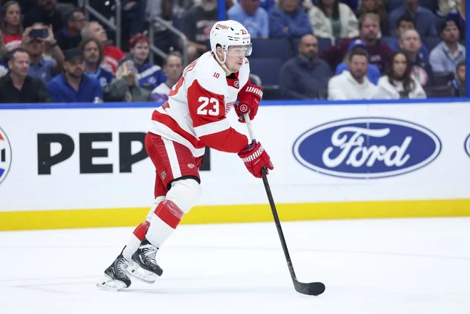 Mar 12, 2026; Tampa, Florida, USA; Detroit Red Wings left wing Lucas Raymond (23) controls the puck against the Tampa Bay Lightning in the first period at Benchmark International Arena.