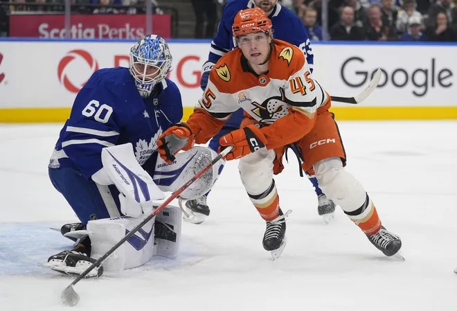 Mar 12, 2026; Toronto, Ontario, CAN; Anaheim Ducks forward Beckett Sennecke (45) and Toronto Maple Leafs goaltender Joseph Woll (60) look for the puck during the second period at Scotiabank Arena.