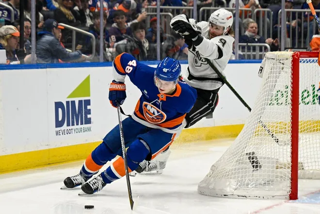 Mar 13, 2026; Elmont, New York, USA; New York Islanders defenseman Matthew Schaefer (48) skates the puck from behind the net chased by Los Angeles Kings right wing Adrian Kempe (9) during the third period at UBS Arena.