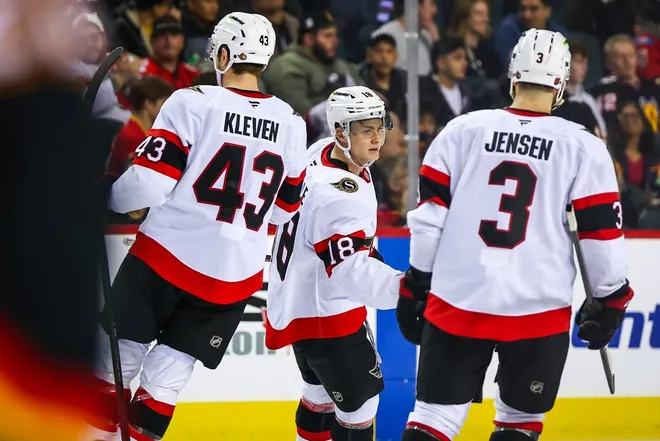 Mar 5, 2026; Calgary, Alberta, CAN; Ottawa Senators center Tim Stützle (18) celebrates his goal with teammates against the Calgary Flames during the third period at Scotiabank Saddledome.