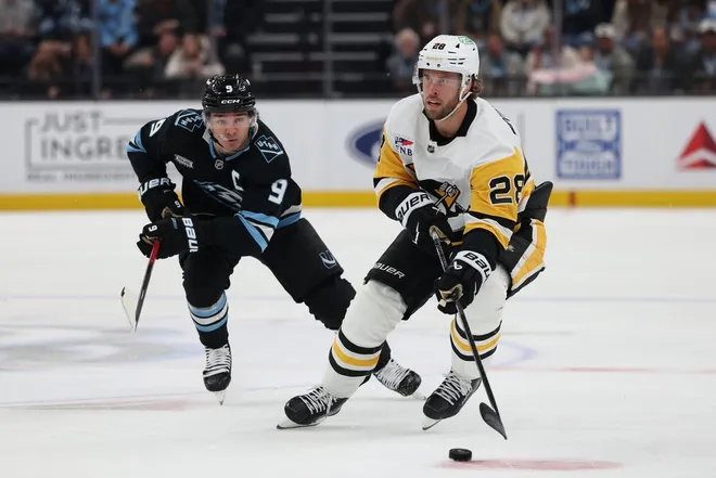 Mar 14, 2026; Salt Lake City, Utah, USA; Pittsburgh Penguins defenseman Parker Wotherspoon (28) skates with the puck against Utah Mammoth right wing Clayton Keller (9) during the first period at Delta Center.