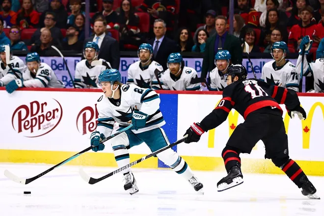 Mar 15, 2026; Ottawa, Ontario, CAN; San Jose Sharks center Will Smith (2) skates with the puck against Ottawa Senators defenseman Jordan Spence (10) during the second period at Canadian Tire Centre.