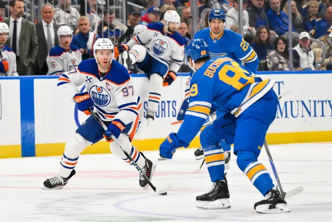 Mar 13, 2026; St. Louis, Missouri, USA; Edmonton Oilers center Connor McDavid (97) controls the puck as St. Louis Blues left wing Pavel Buchnevich (89) defends during the first period at Enterprise Center.