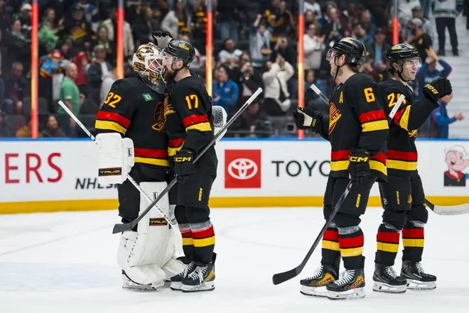 Mar 17, 2026; Vancouver, British Columbia, CAN; Vancouver Canucks goalie Kevin Lankinen (32), defenseman Filip Hronek (17), forward Brock Boeser (6) and defenseman Zeev Buium (24) celebrate their victory against the Florida Panthers at Rogers Arena.