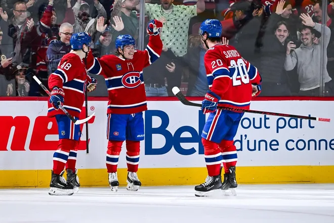 Mar 17, 2026; Montreal, Quebec, CAN; Montreal Canadiens right wing Cole Caufield (13) celebrates with his teammates his game winning goal in overtime against the Boston Bruins at Bell Centre.