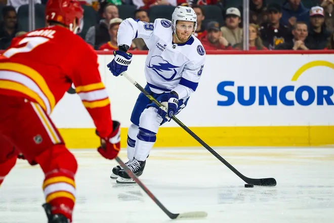 Mar 22, 2026; Calgary, Alberta, CAN; Tampa Bay Lightning center Jake Guentzel (59) controls the puck against the Calgary Flames during the first period at Scotiabank Saddledome.