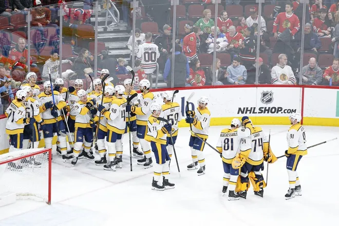 Mar 22, 2026; Chicago, Illinois, USA; Nashville Predators left wing Filip Forsberg (9) celebrates with teammates after scoring a game winning goal against the Chicago Blackhawks in overtime at United Center.