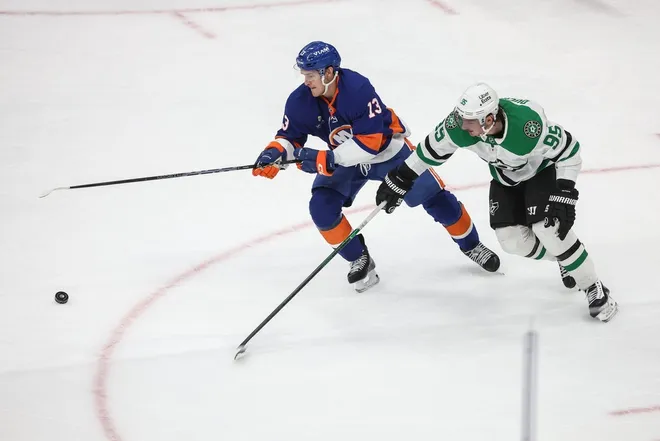 Mar 26, 2026; Elmont, New York, USA; New York Islanders center Mathew Barzal (13) and Dallas Stars center Matt Duchene (95) battle for control of the puck in the first period at UBS Arena.