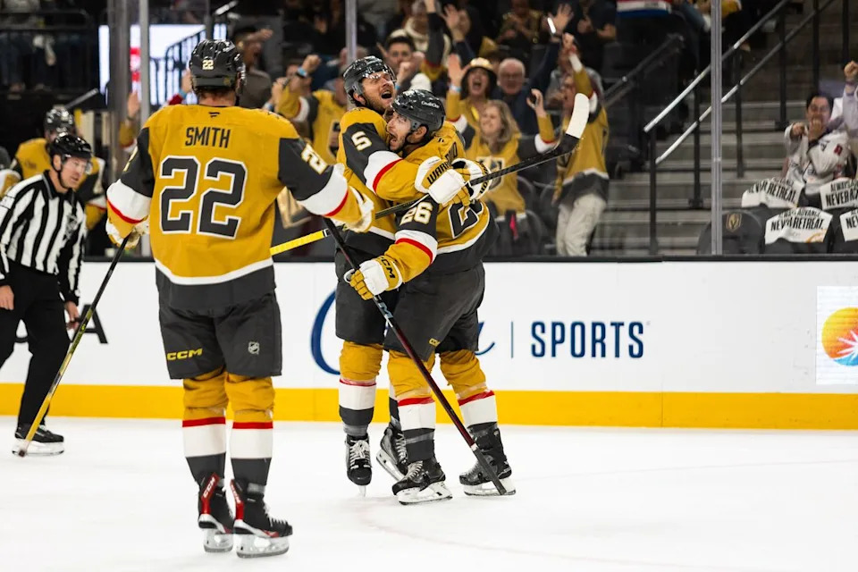 Vegas Golden Knights defenseman Jeremy Lauzon (5) embraces center Nic Dowd (26) after Dowd scores a goal during a NHL game between the Vegas Golden Knights and the Washington Capitals, Saturday March 28, 2026 in Las Vegas, Nev.