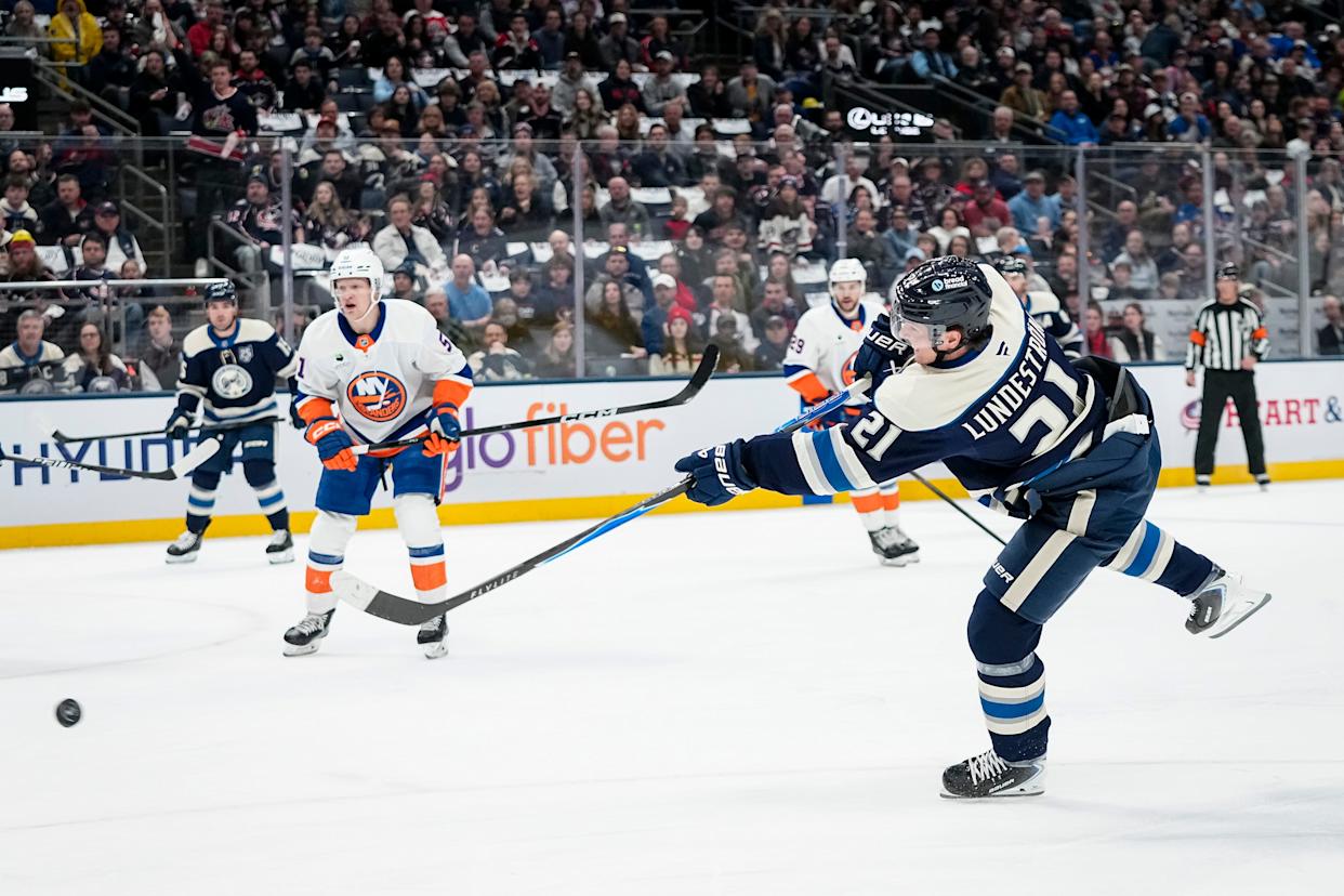 Columbus Blue Jackets center Isac Lundeström (21) shoots during the first period of the NHL hockey game against the New York Islanders at Nationwide Arena in Columbus on Feb. 28, 2026.