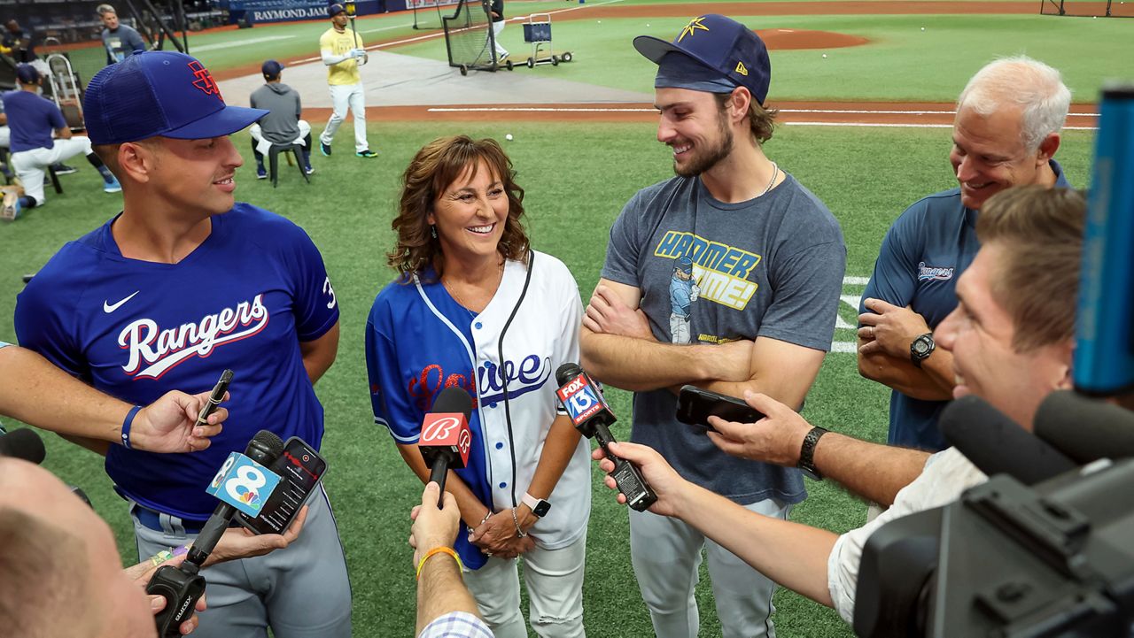 Texas Rangers' Nathaniel Lowe, left, and Tampa Bay Rays' Josh Lowe, third from left, talk to the media along with their parents Wendy Lowe, second from left, and David Lowe, back right, prior to a baseball game June 9, 2023, in St. Petersburg, Fla. (AP Photo/Mike Carlson, File)