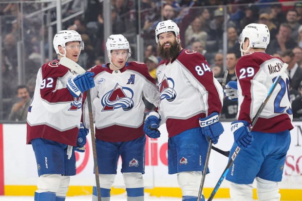 Colorado Avalanche left wing Gabriel Landeskog, left, celebrate with defenseman Cale Makar, defenseman Brent Burns, and center Nathan MacKinnon after scoring during the first period of an NHL hockey game against the Los Angeles Kings Monday, March, 2, 2026 in Los Angeles. (AP Photo/Ryan Sun)