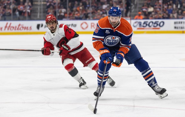 Carolina Hurricanes' Seth Jarvis (24) chases Edmonton Oilers' Jason Dickinson (16) during second-period NHL action in Edmonton, Alberta, on Friday March 6, 2026. (Jason Franson/The Canadian Press via AP)
