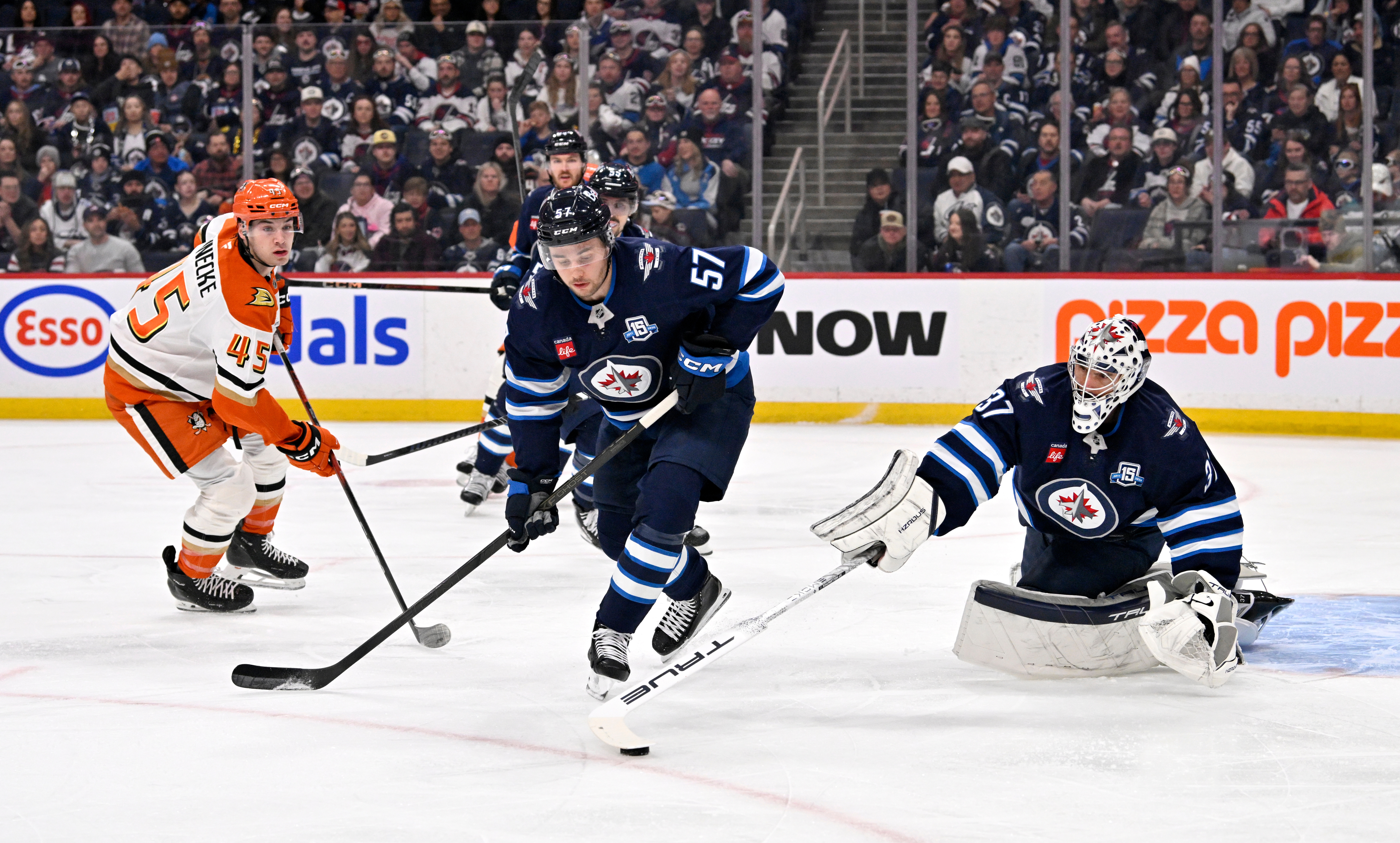 Winnipeg Jets goaltender Connor Hellebuyck, right, and teammate Elias Salomonsson...