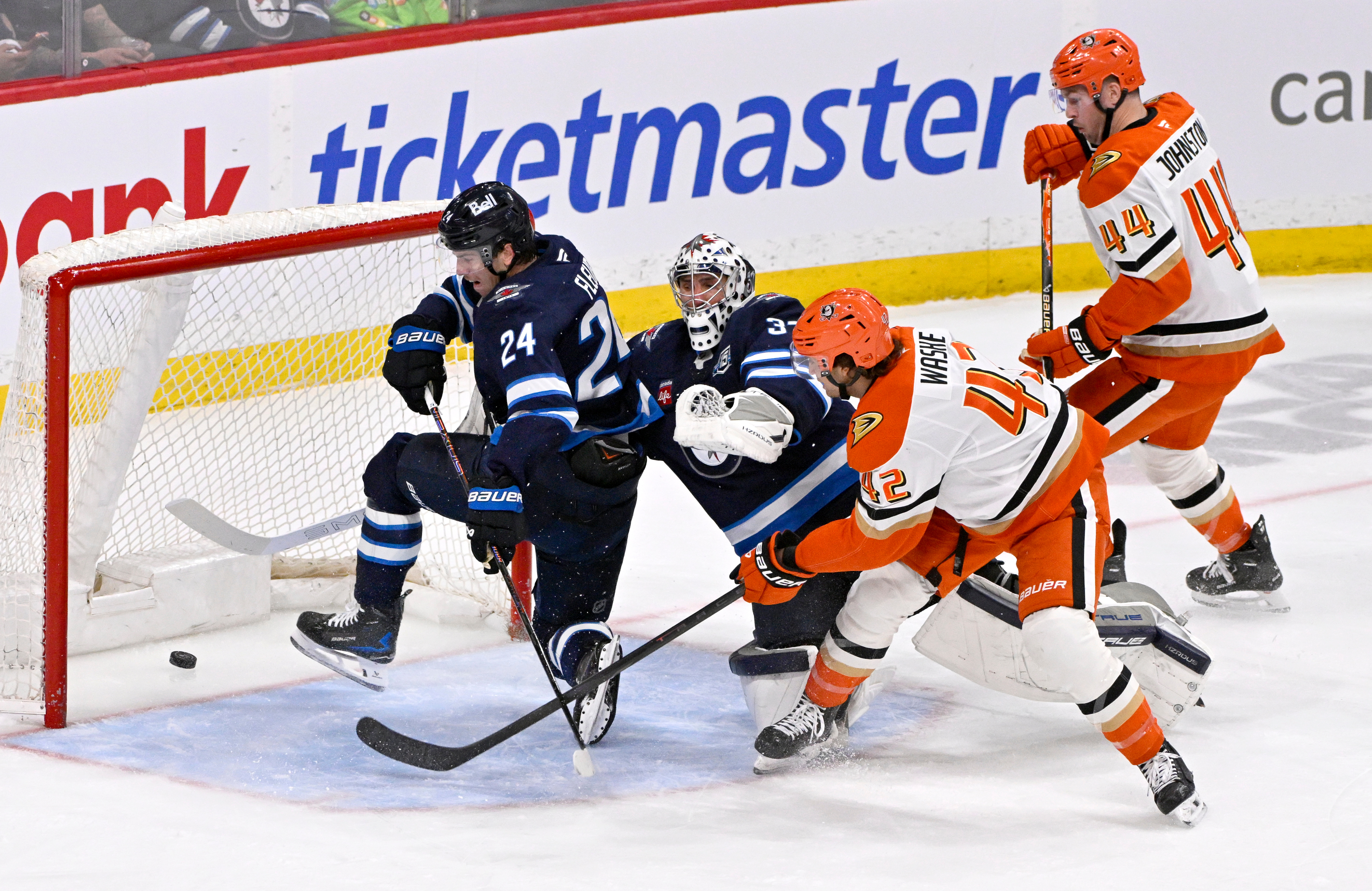 The Ducks’ Tim Washe (42) scores past Winnipeg Jets goaltender...