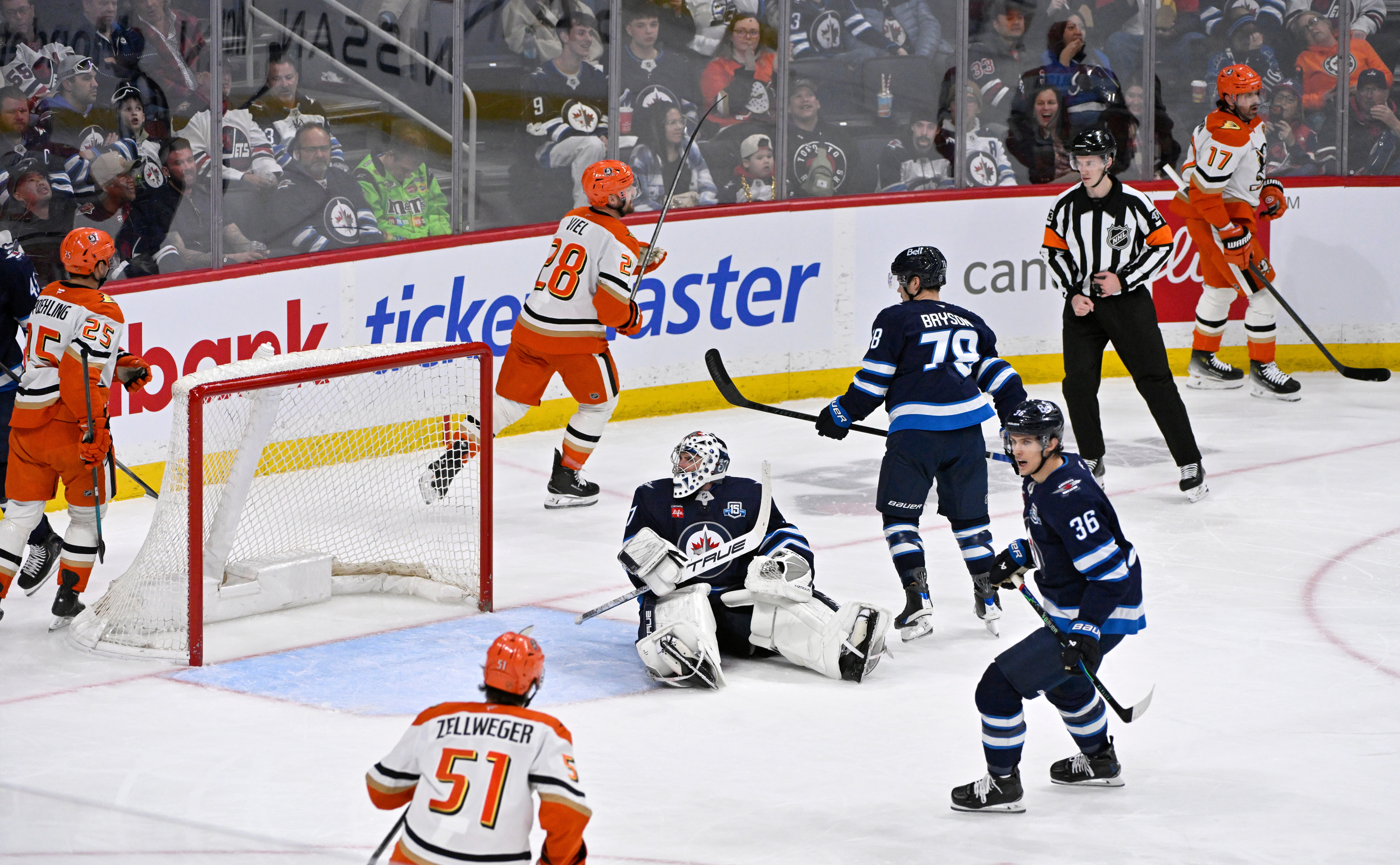 Winnipeg Jets goaltender Connor Hellebuyck (37) sits on the ice...