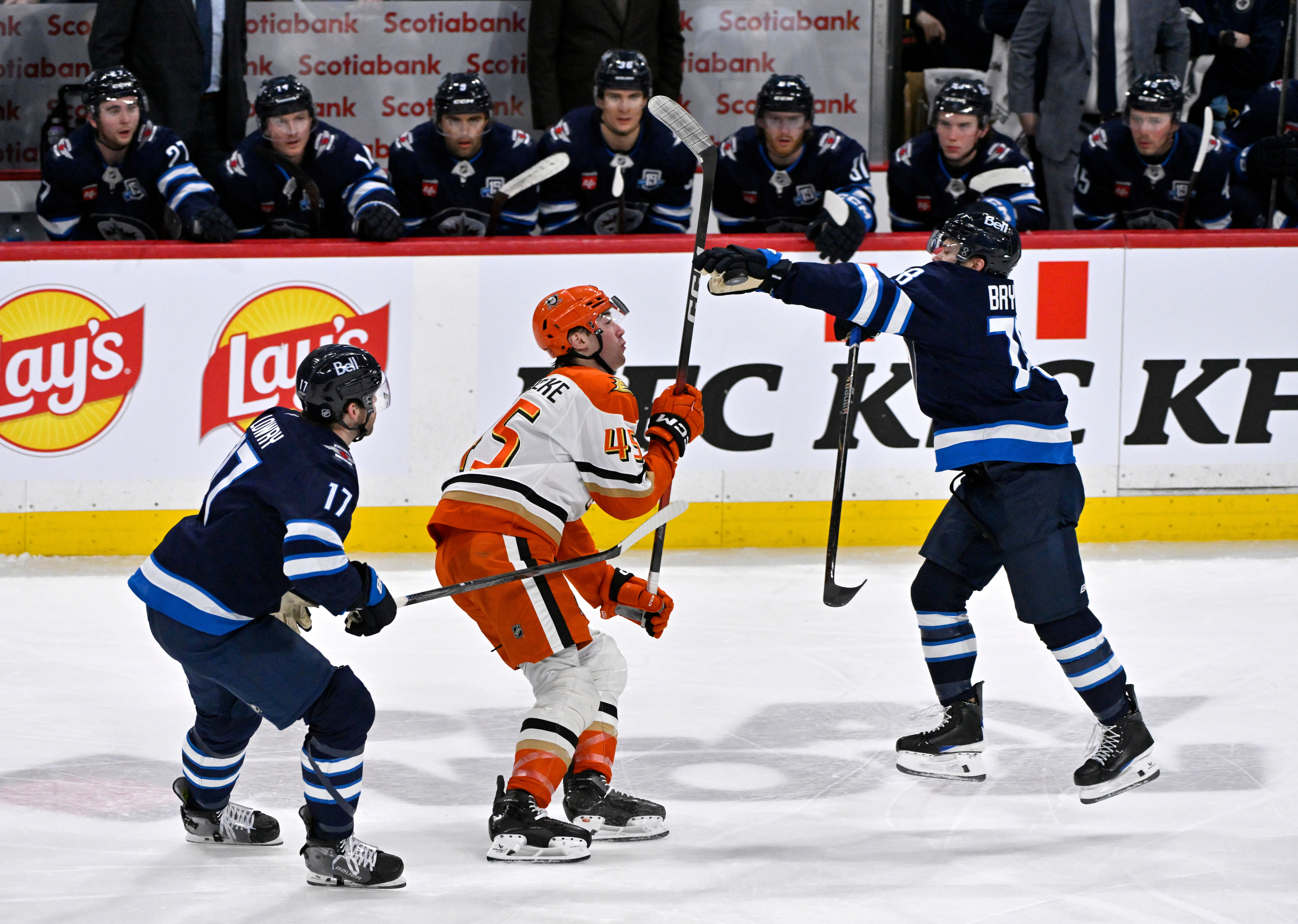 The Winnipeg Jets’ Jacob Bryson, right, reaches for a bouncing...