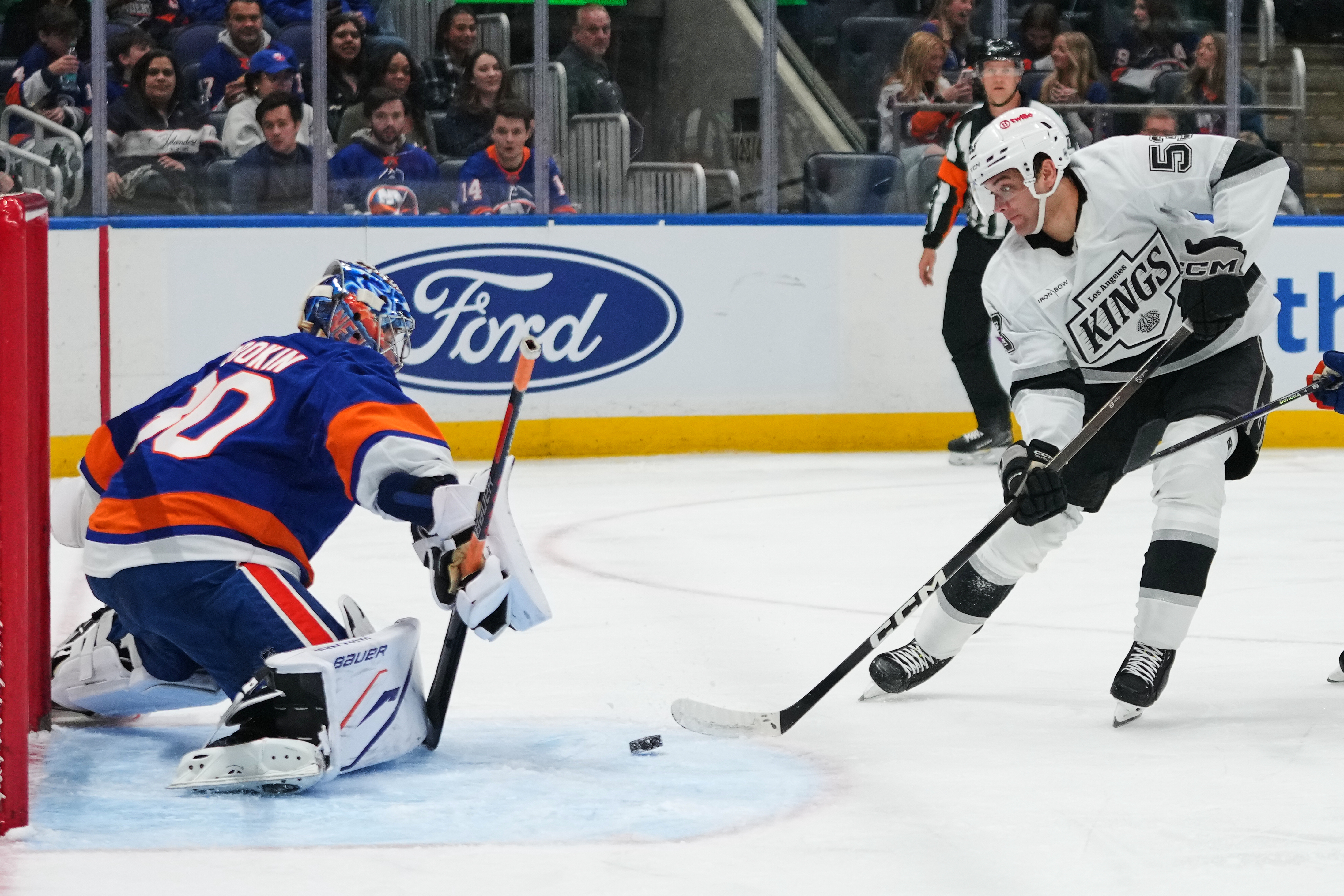 New York Islanders goaltender Ilya Sorokin, left, protects the net...