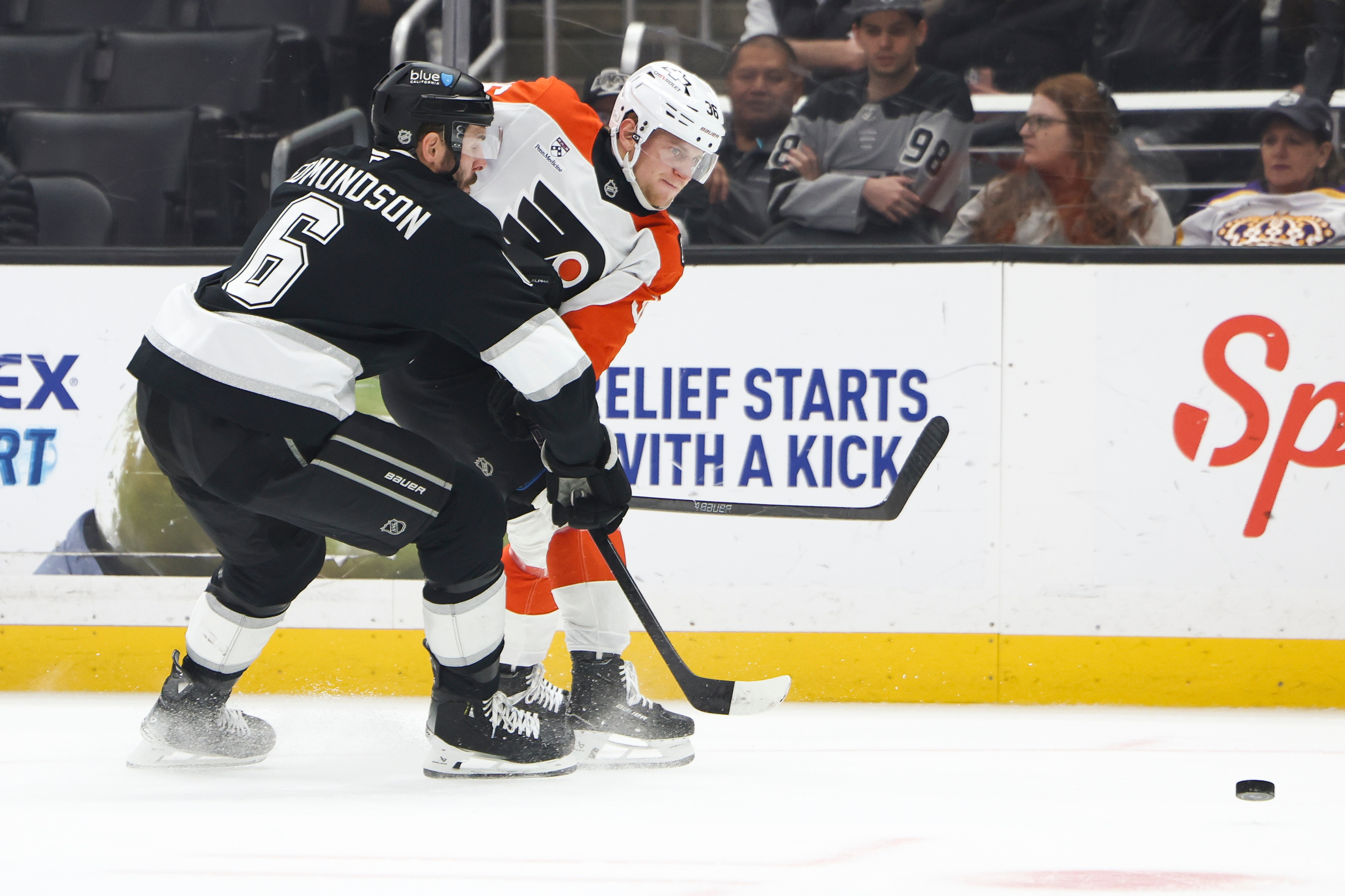 Philadelphia Flyers defenseman Emil Andrae, right, passes the puck against...