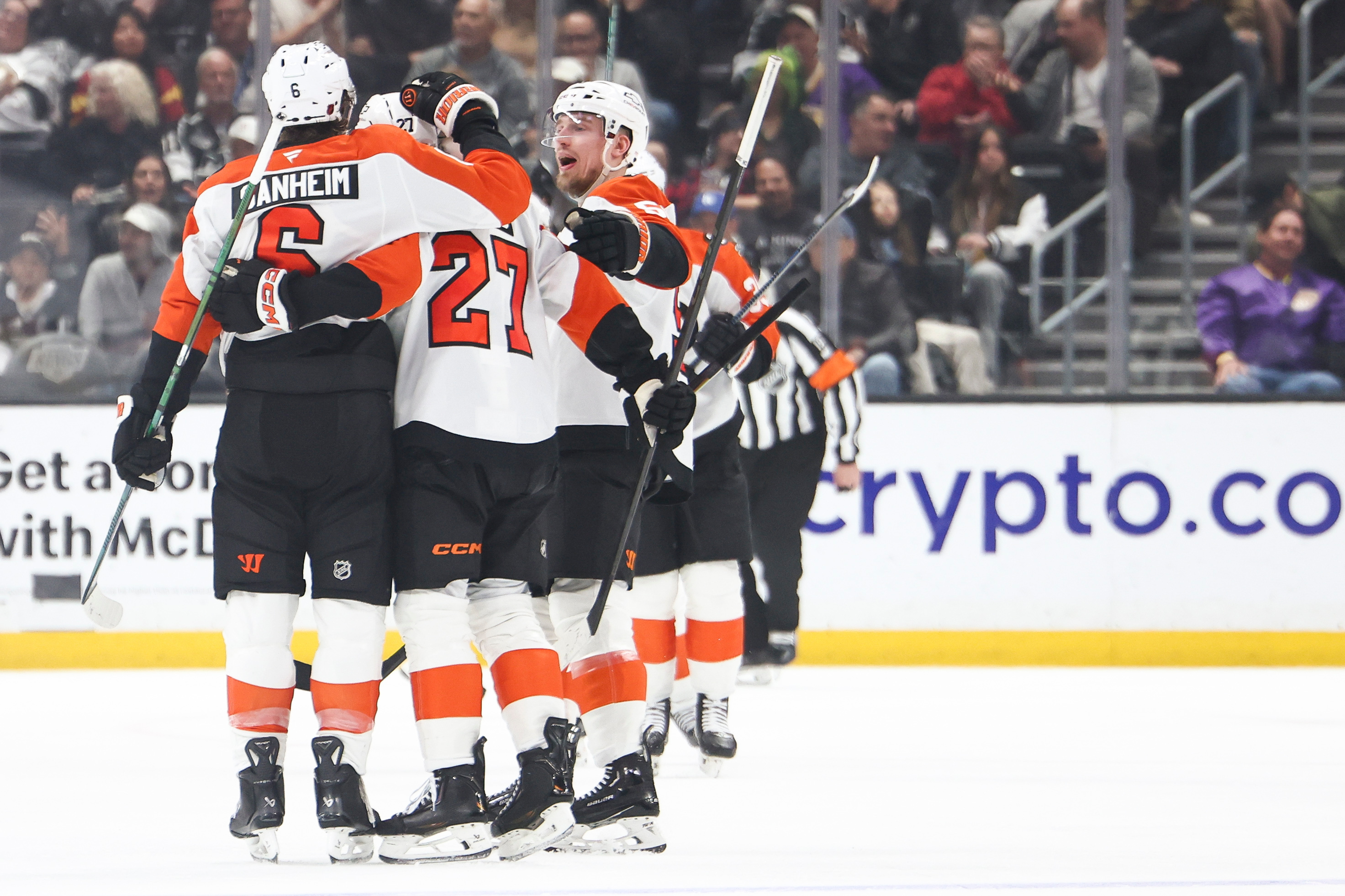 Philadelphia Flyers defenseman Travis Sanheim, left, celebrates with left wing...