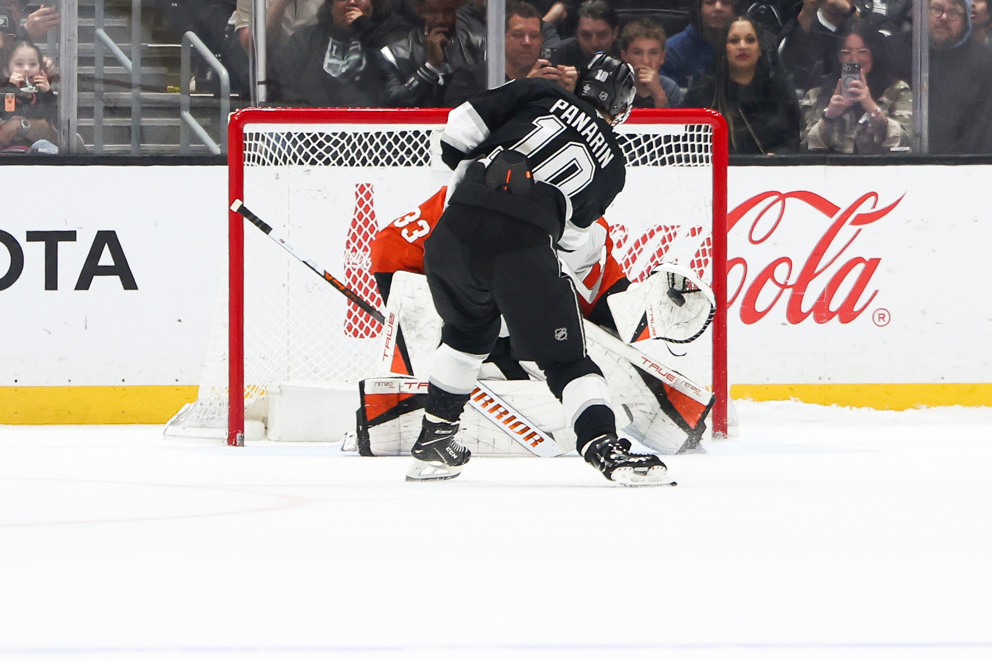 Philadelphia Flyers goaltender Samuel Ersson, back, saves a shot by...