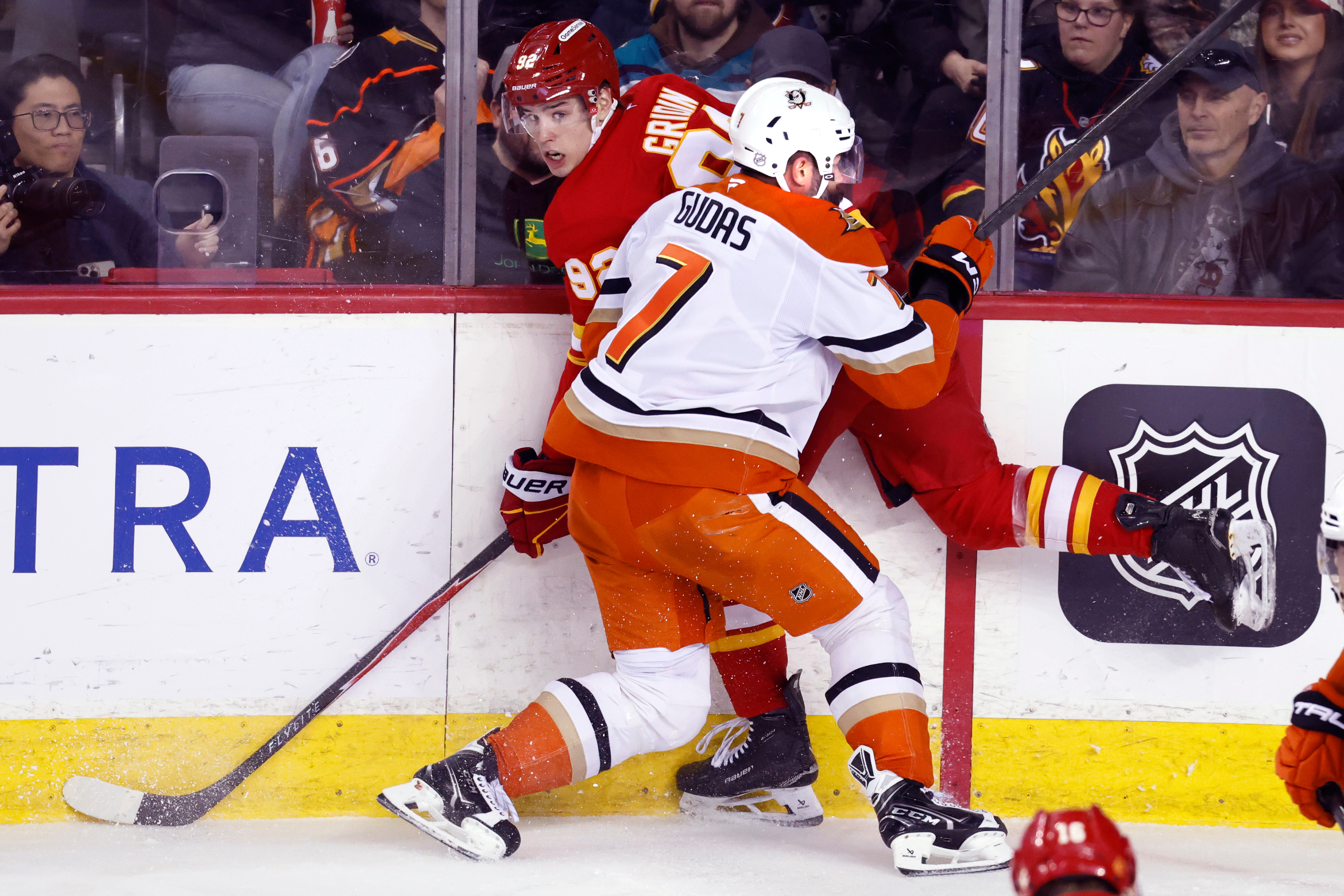 Ducks defenseman Radko Gudas, front, hits the Calgary Flames’ Matvei...