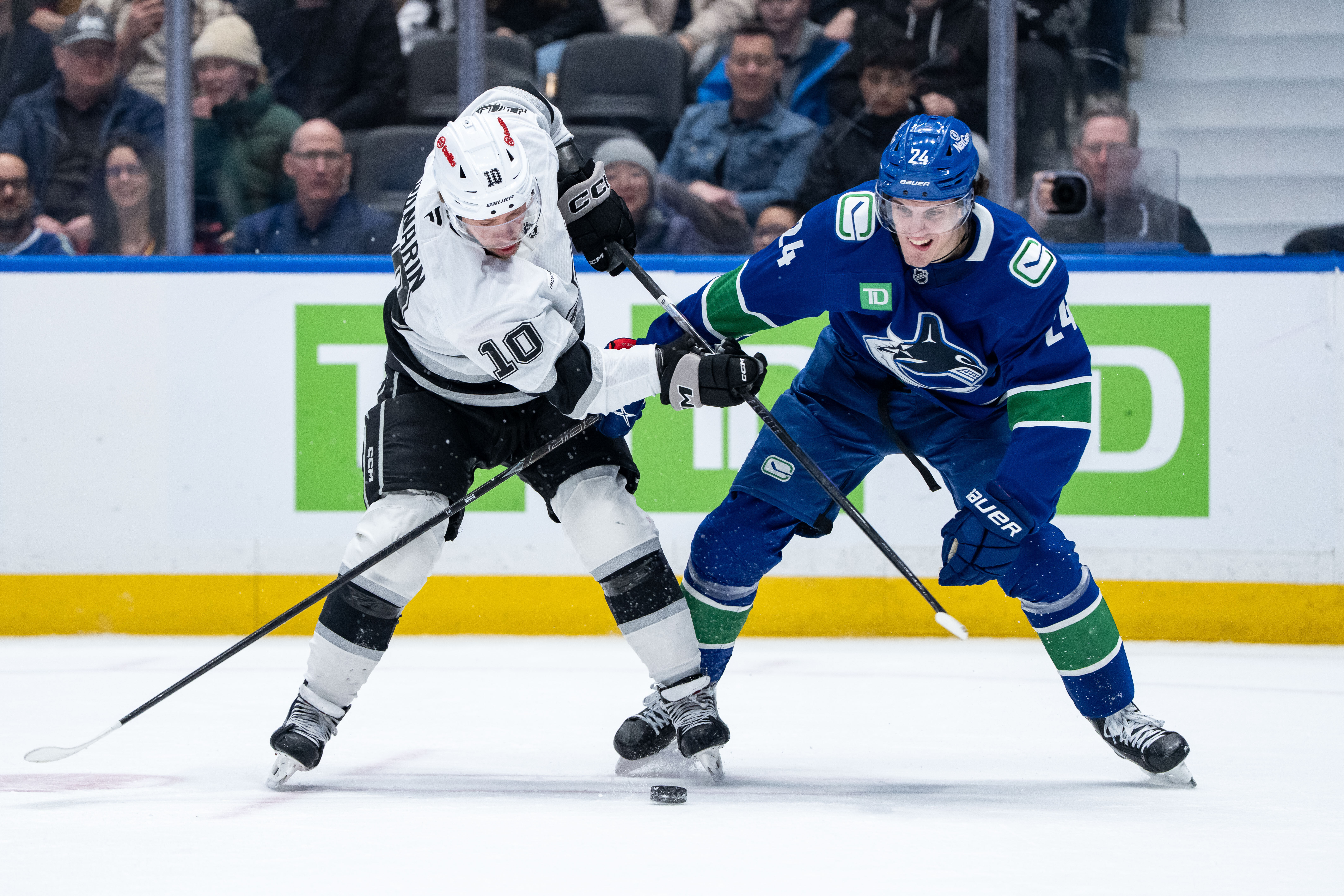 The Kings’ Artemi Panarin, left, and the Vancouver Canucks’ Zeev...