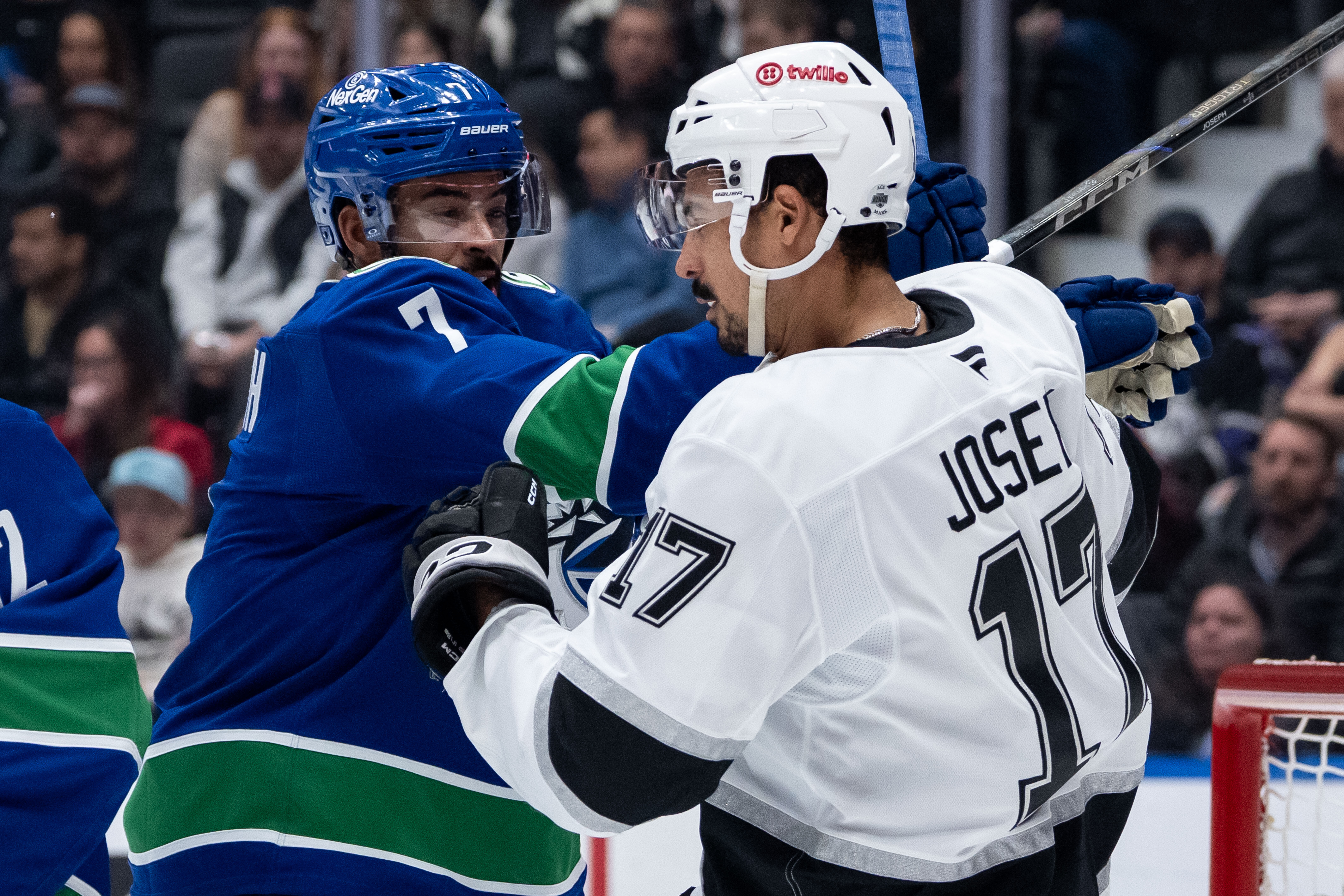 The Vancouver Canucks’ Pierre-Olivier Joseph, left, hits the Kings’ Mathieu...