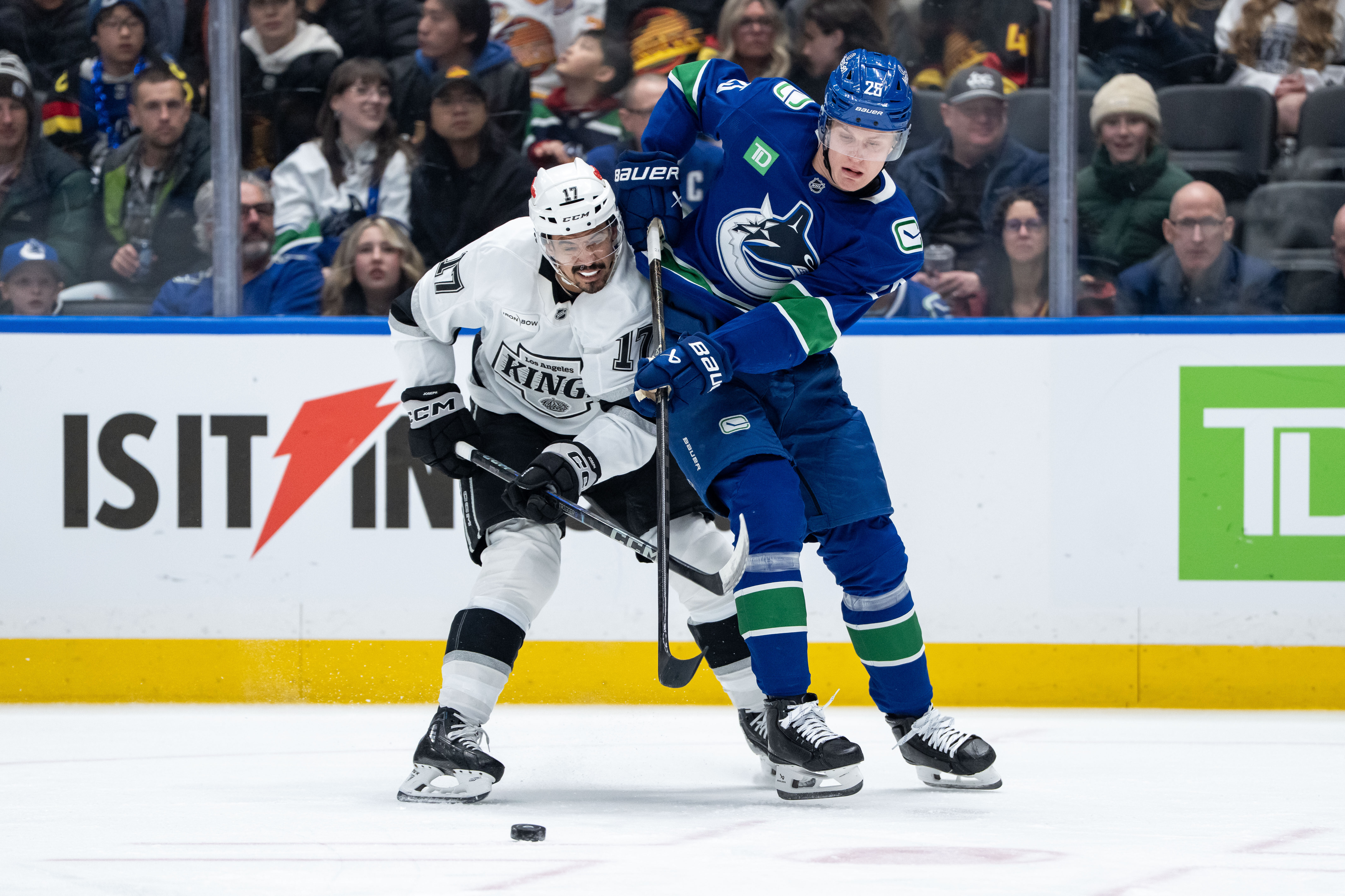 The Kings’ Mathieu Joseph, left, and the Vancouver Canucks’ Elias...