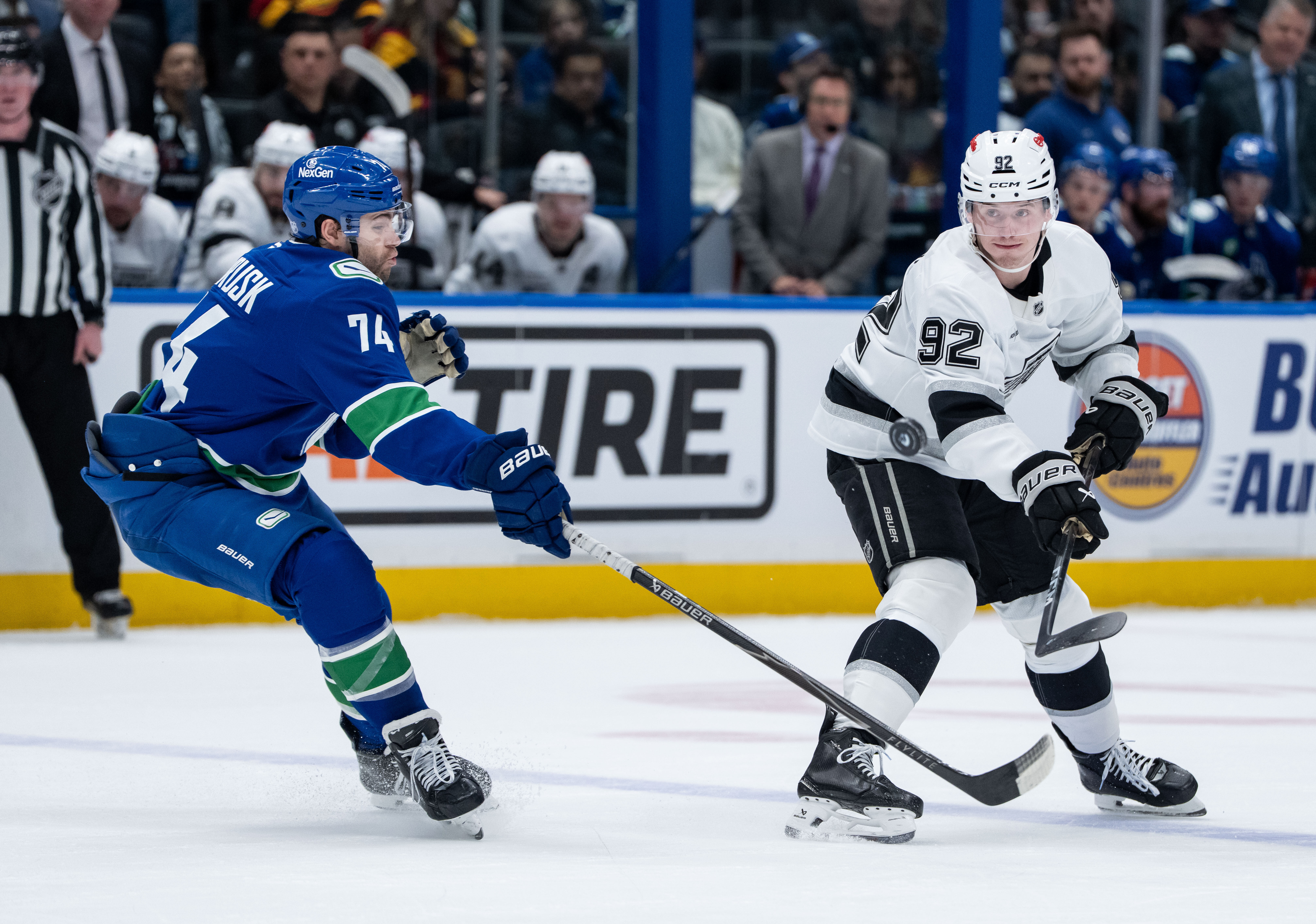 The Vancouver Canucks’ Jake DeBrusk, left, and the Kings’ Brandt...