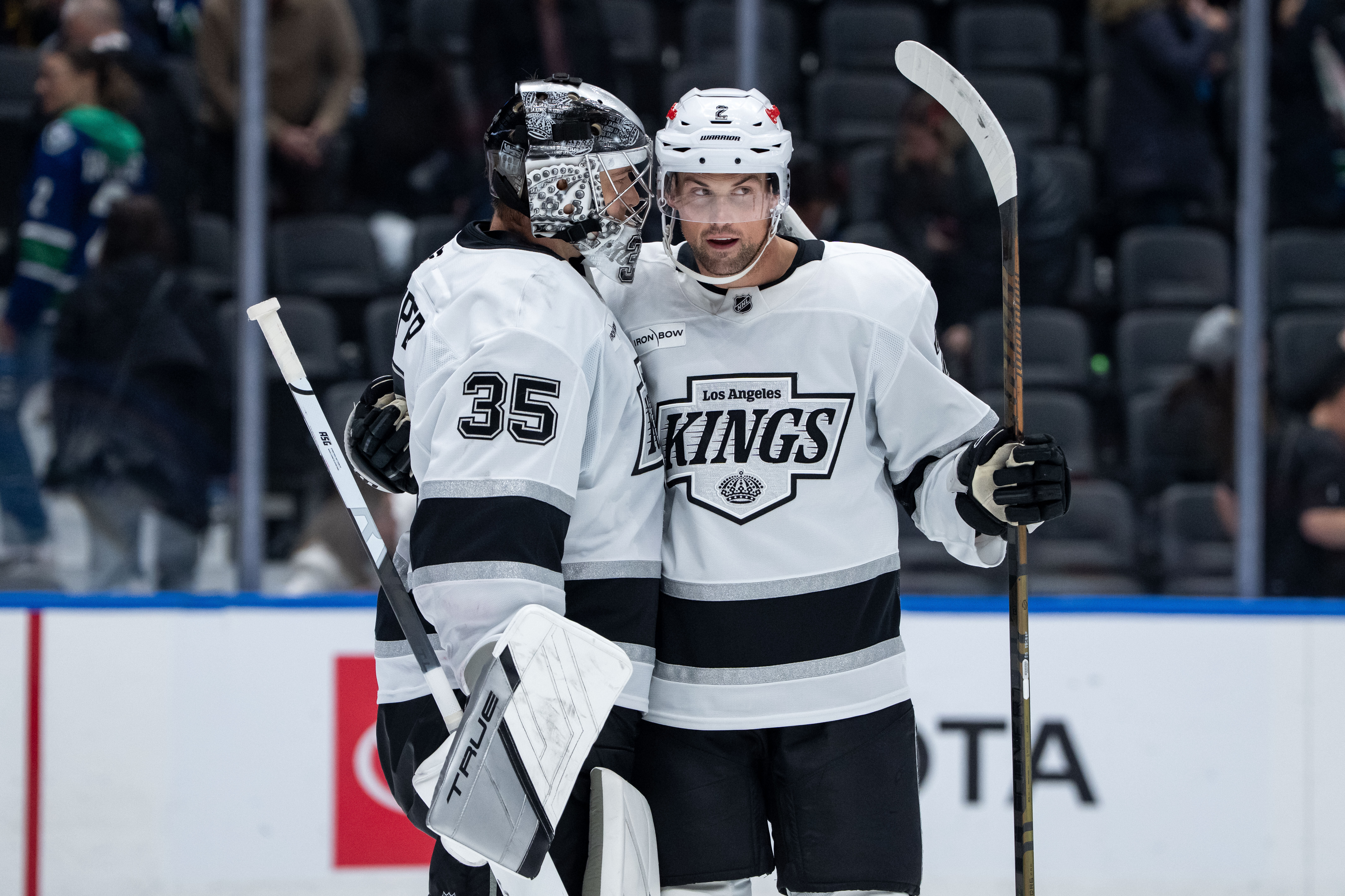Kings goaltender Darcy Kuemper, left, celebrates with Brian Dumoulin after...