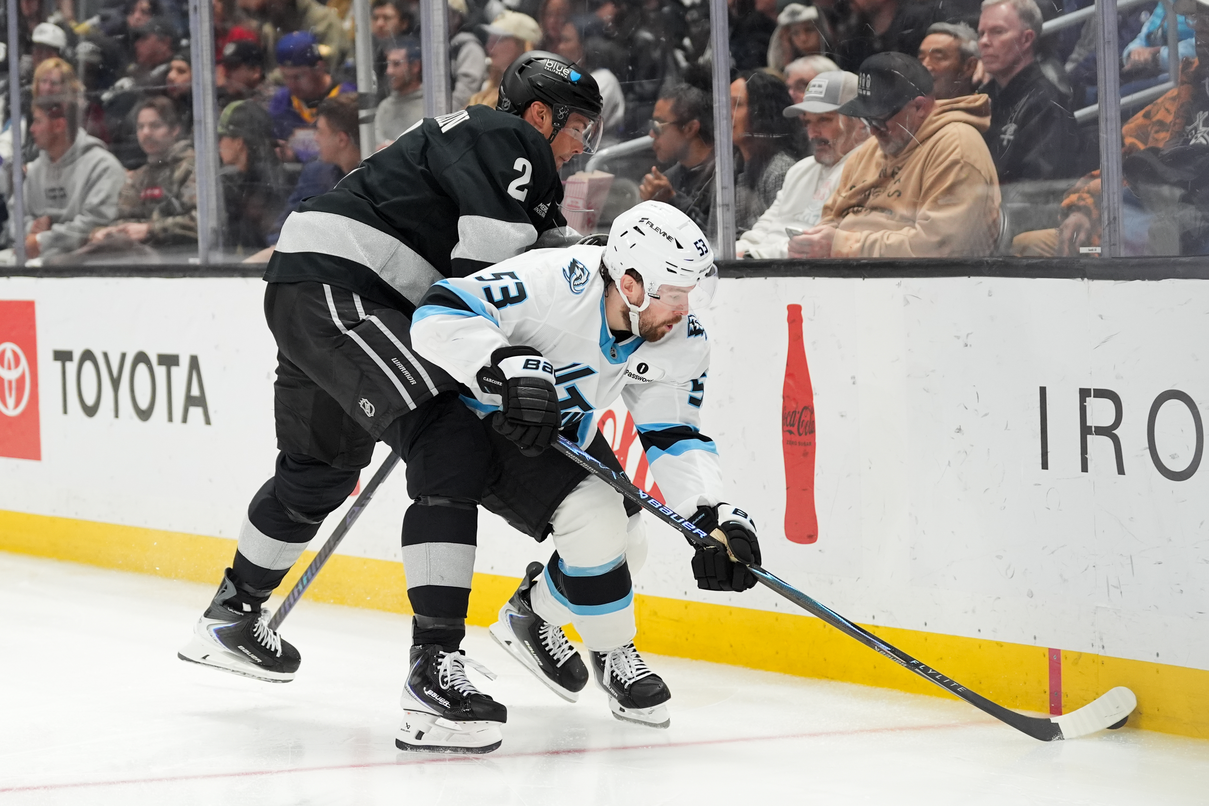 Kings defenseman Brian Dumoulin (2) shoves Utah Mammoth left wing...