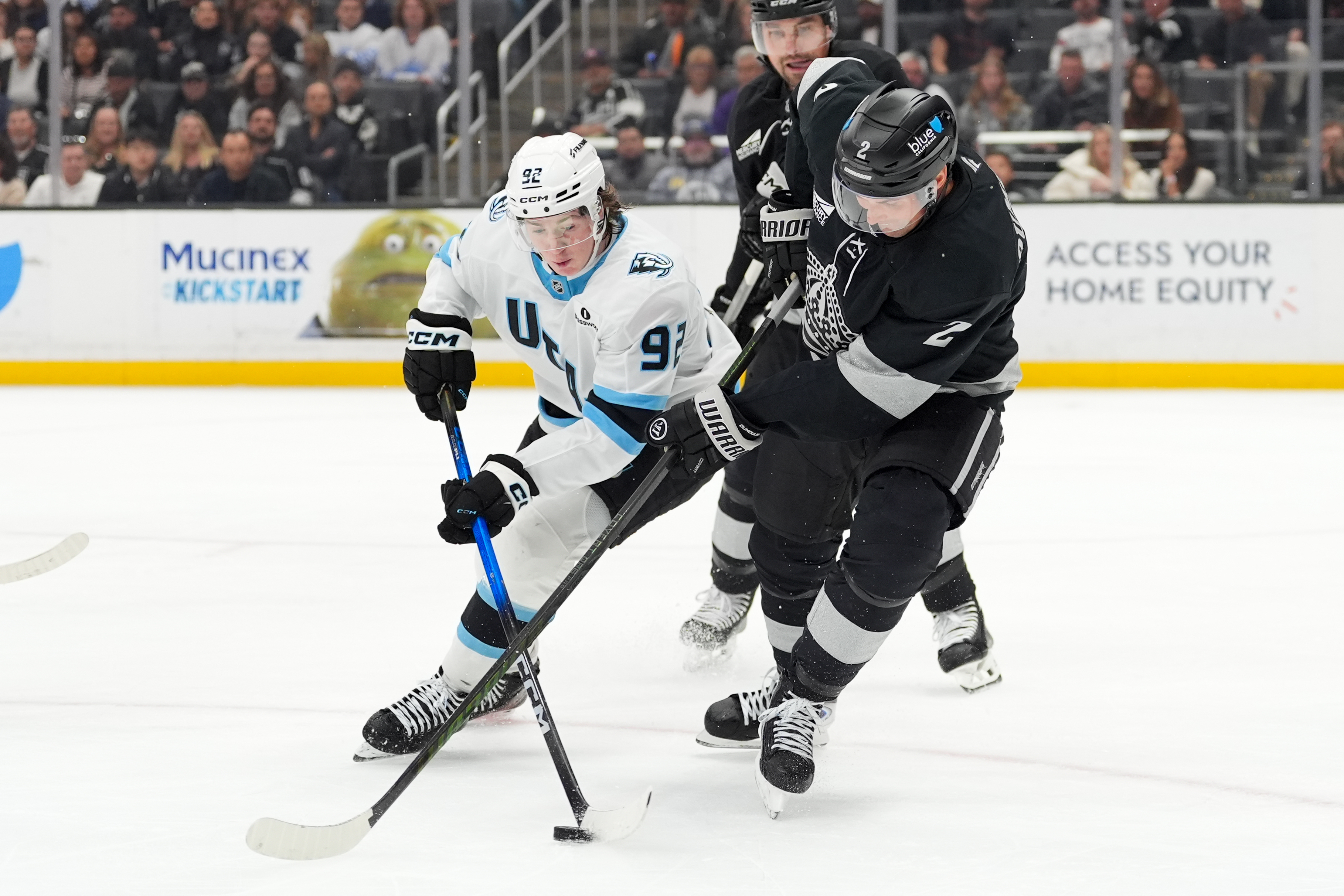 Utah Mammoth center Logan Cooley (92) is pressured by Kings...