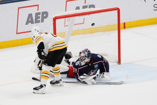 Boston Bruins' Viktor Arvidsson, left, scores the game-winning goal against Columbus Blue Jackets' Jet Greaves during the shootout of an NHL game, Sunday, March 29, 2026, in Columbus, Ohio. (AP Photo/Jay LaPrete)