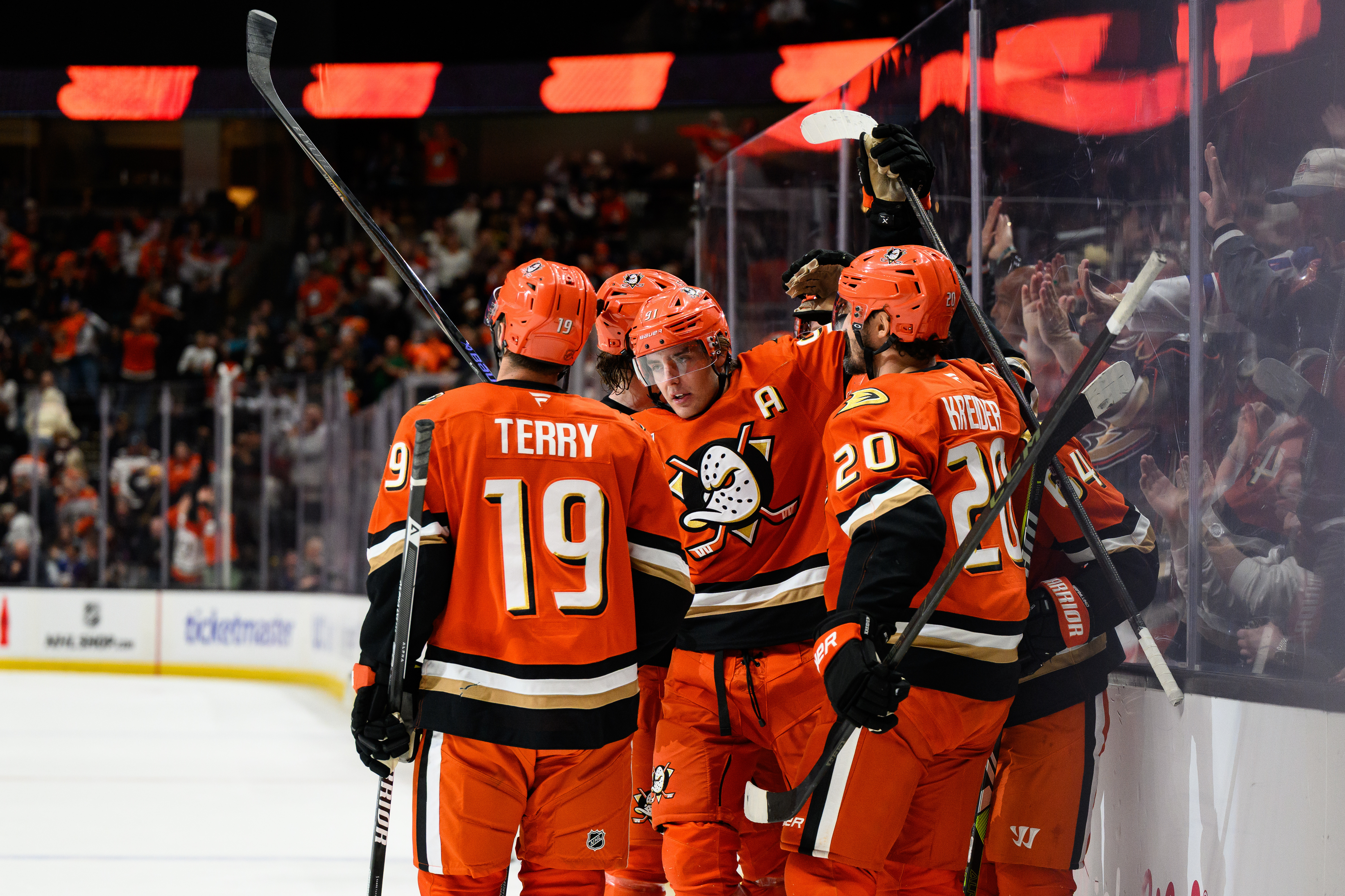 Ducks center Leo Carlsson (91) is greeted by teammates after...