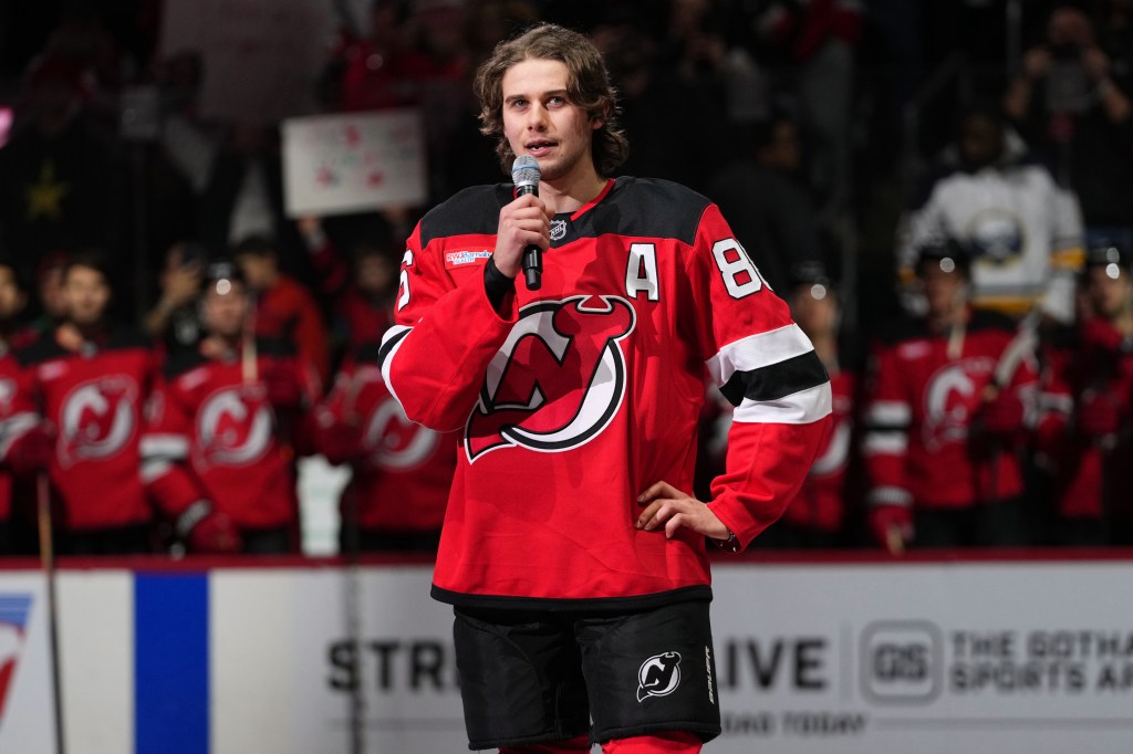 New Jersey Devils' Jack Hughes speaks to fans before an NHL hockey game against the Buffalo Sabres Wednesday, Feb. 25, 2026, in Newark, N.J. 