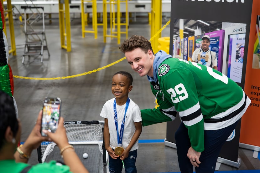 Dallas Stars goalie Jake Oettinger (right) poses for a photo during a HopeKids visit to...