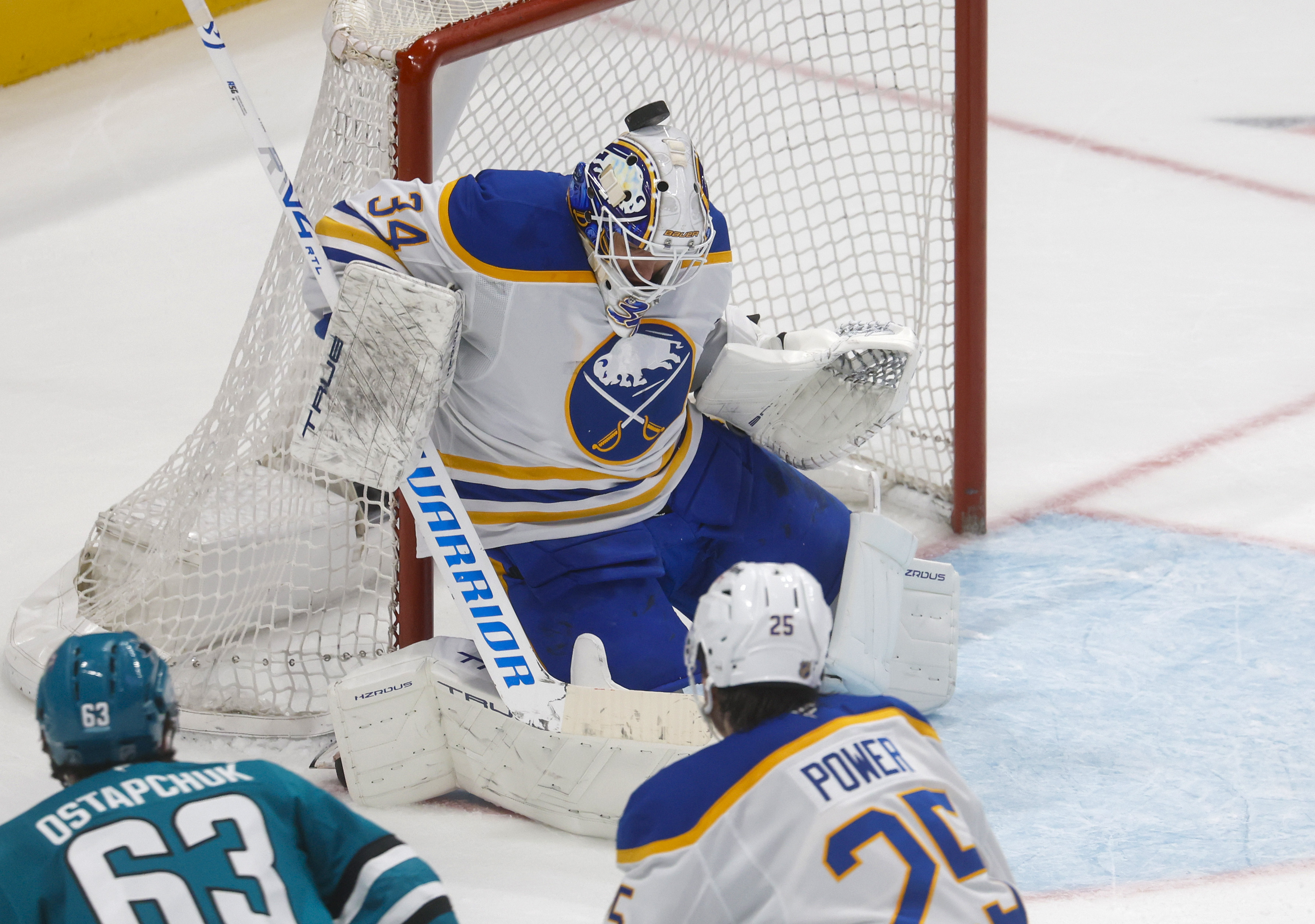 The puck lands on the head of Buffalo Sabres goaltender...