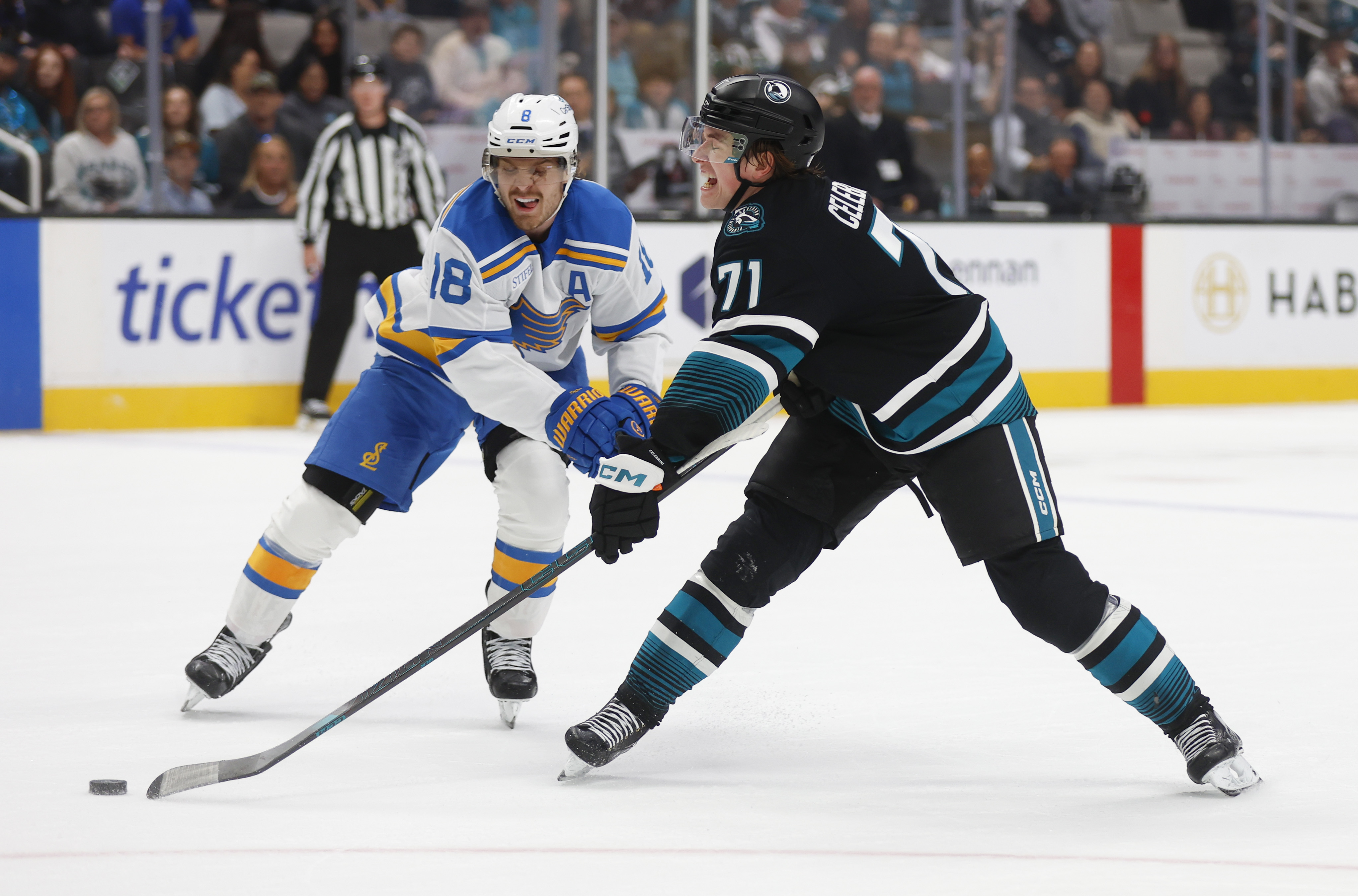 San Jose Sharks’ Macklin Celebrini (71) tries to get a...