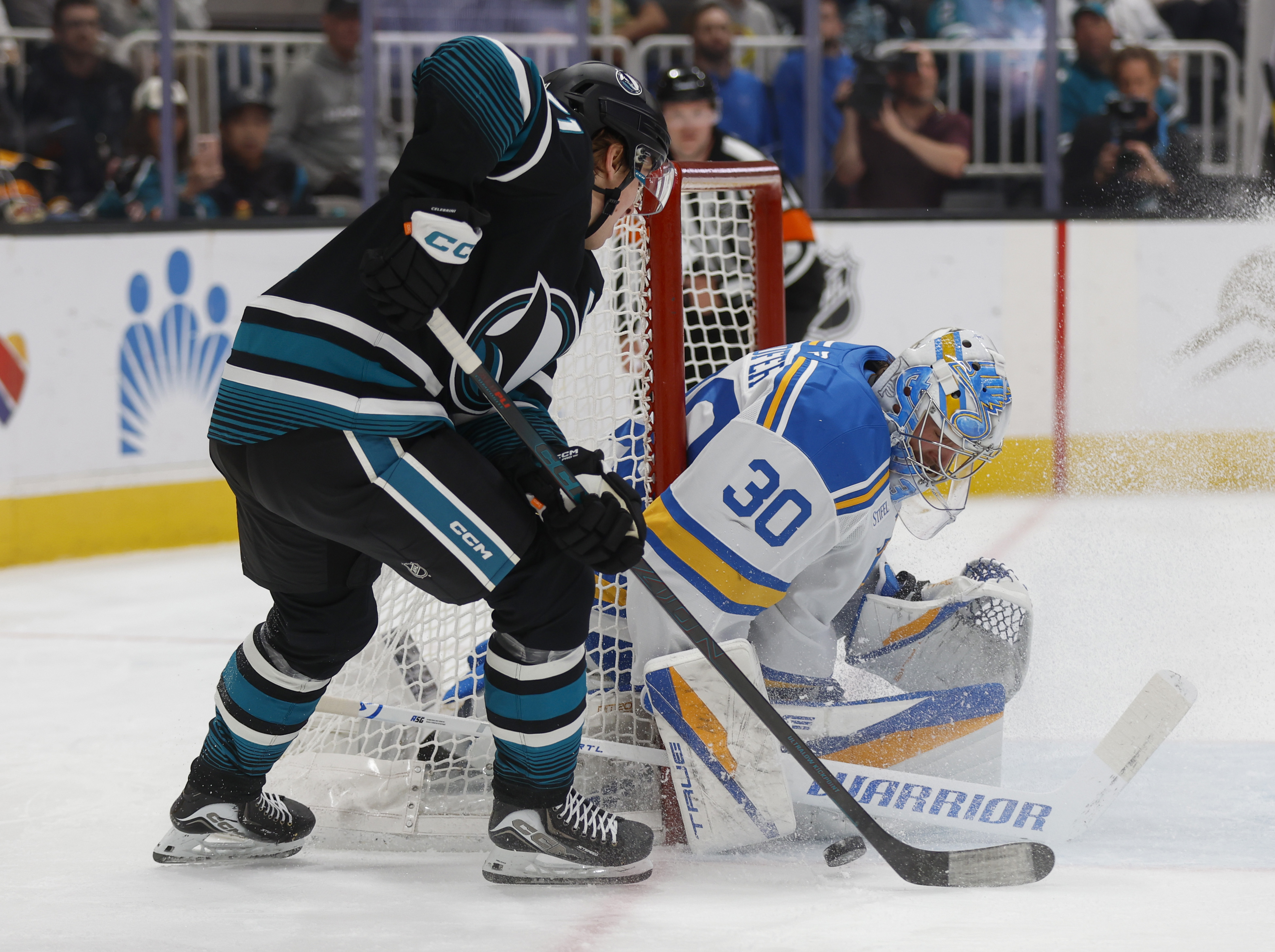 San Jose Sharks’ Macklin Celebrini (71) tries to get a...