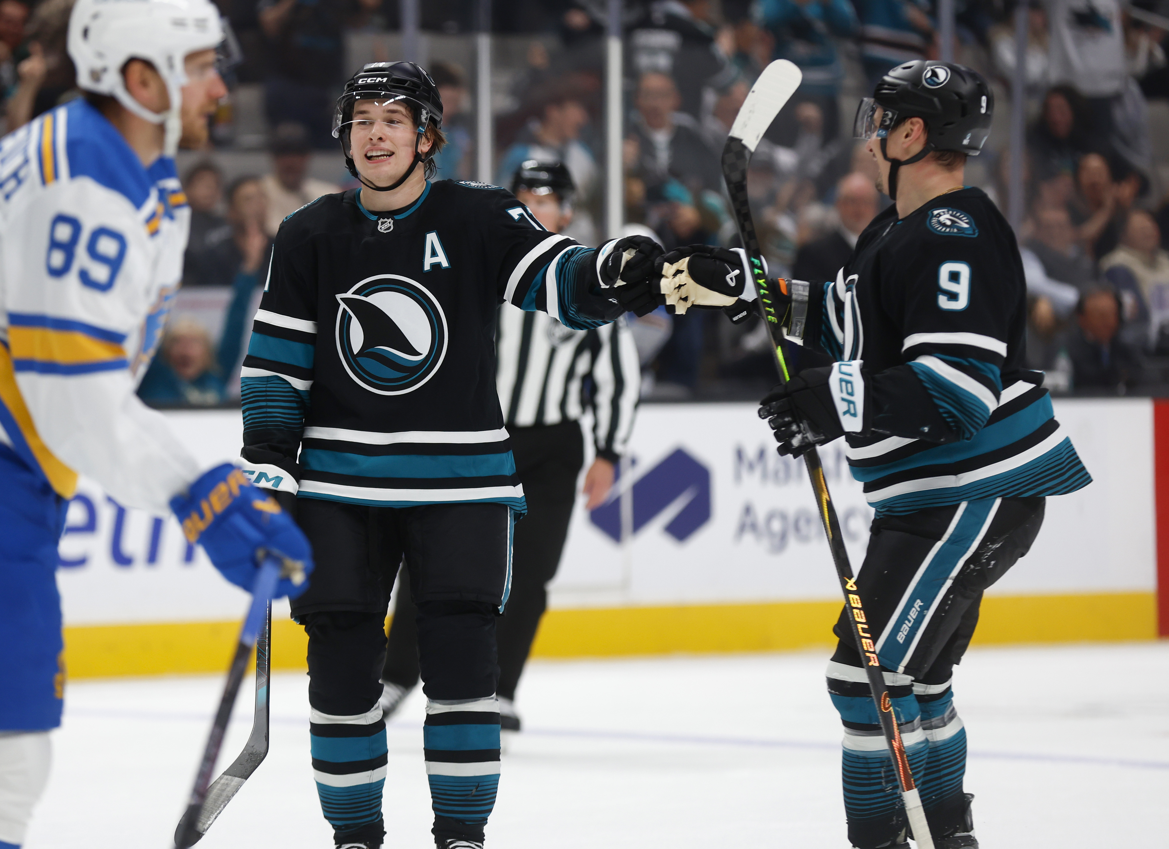 San Jose Sharks’ Macklin Celebrini (71) high-fives San Jose Sharks’...