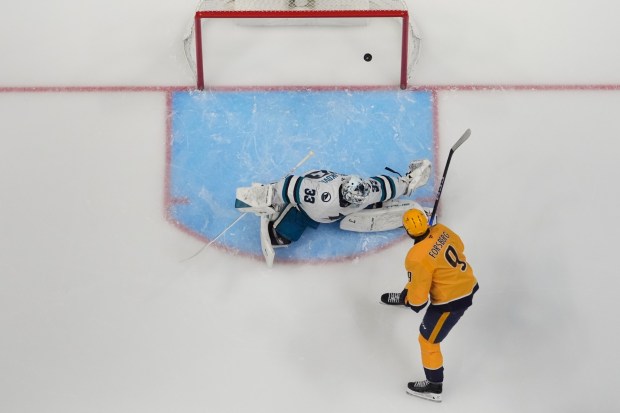 Nashville Predators left wing Filip Forsberg (9) scores a goal past San Jose Sharks goaltender Alex Nedeljkovic (33) during the first period of an NHL hockey game Tuesday, March 24, 2026, in Nashville, Tenn. (AP Photo/George Walker IV)