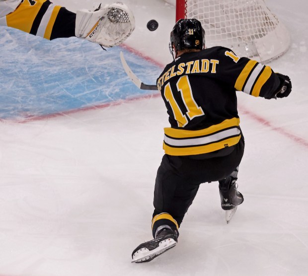 Boston Bruins center Casey Mittelstadt (11) shoots his goal past the glove of Pittsburgh Penguins goaltender Stuart Skinner (74) as the Bruins take on the Penguins at TD Garden. (Staff photo by Stuart Cahill)