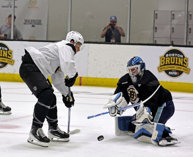 James Hagens, left breaks in on goaltender Albin Boija as the Bruins hold Development Camp at Warrior Ice Arena this past summer. (Staff Photo By Stuart Cahill/Boston Herald)