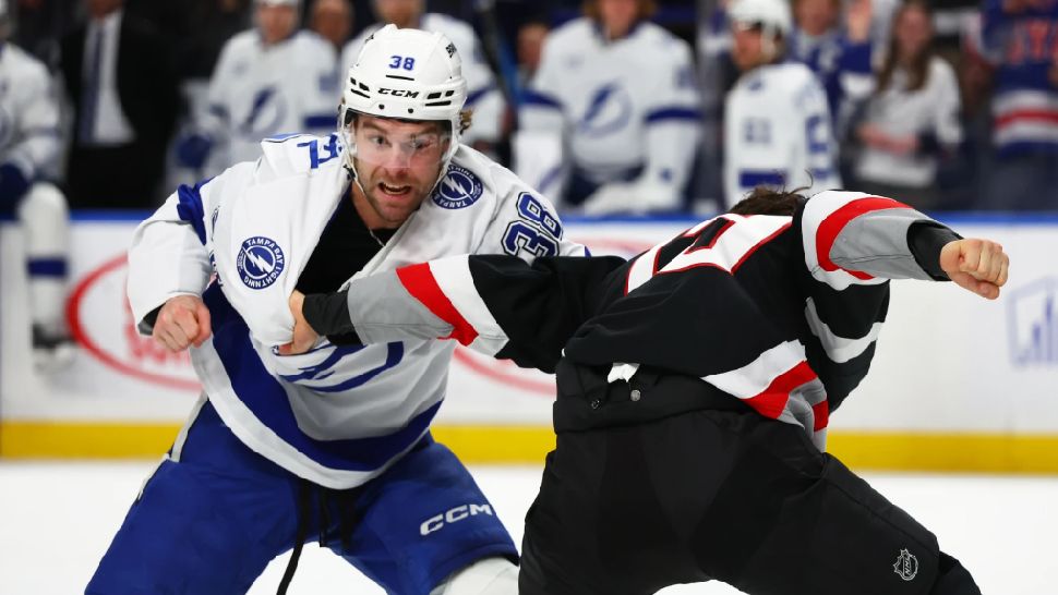 Tampa Bay Lightning left wing Brandon Hagel (38) and Buffalo Sabres center Peyton Krebs fight during the first period of an NHL hockey game, Sunday, March 8, 2026, in Buffalo, N.Y. (AP Photo/Jeffrey T. Barnes)