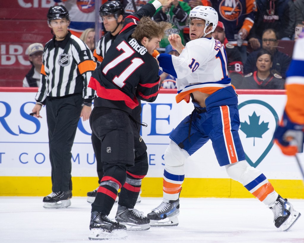 Brayden Schenn, who also scored later in the game, fights with Ridly Greig (left) during the Islanders' road loss to the Senators.